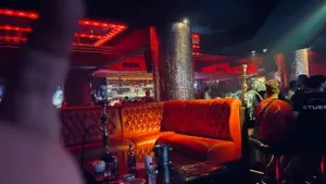 Luxurious club interior with cozy sofa and neon lights, showcasing the vibrant Nightlife Kuta Bali experience.