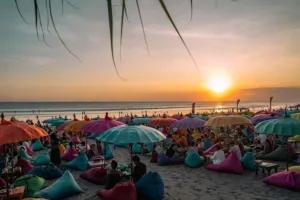 Beachfront bar with umbrellas and bean bags during sunset, offering a chill side of Nightlife Kuta Bali.